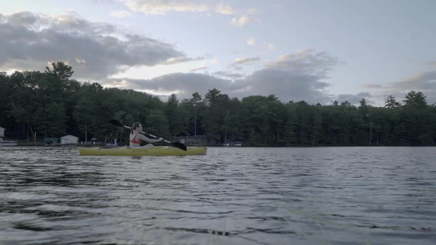 A woman rows out onto the water