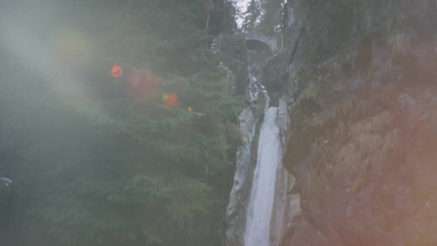 A waterfall flows from atop a mountain