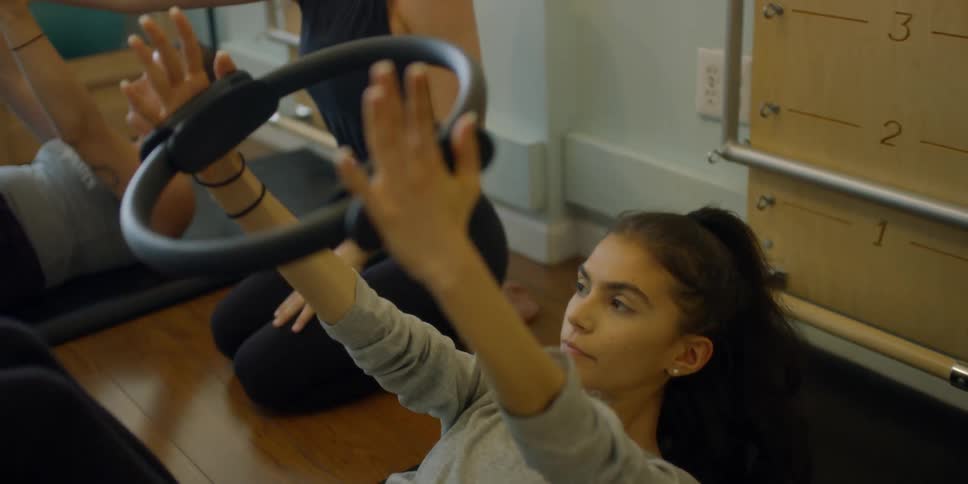 Woman trains several women during exercise class
