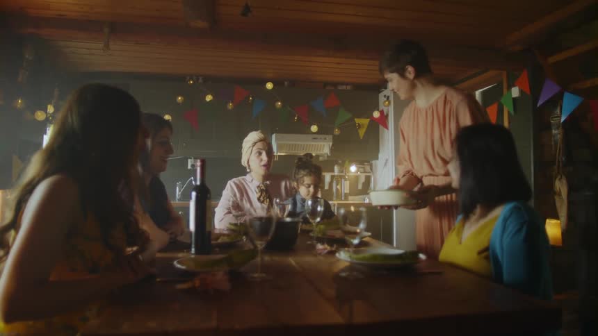 Five adults and one child eat at a table