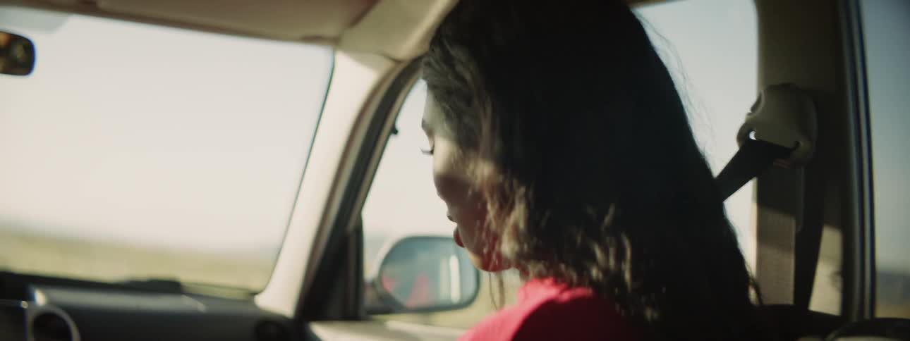 Woman riding in passenger seat of car