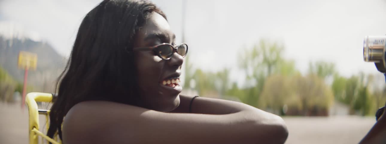 A female using a video camera to record herself