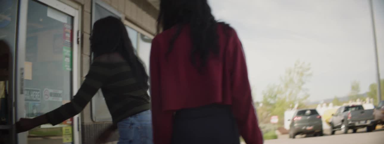 Two women walk into a grocery store