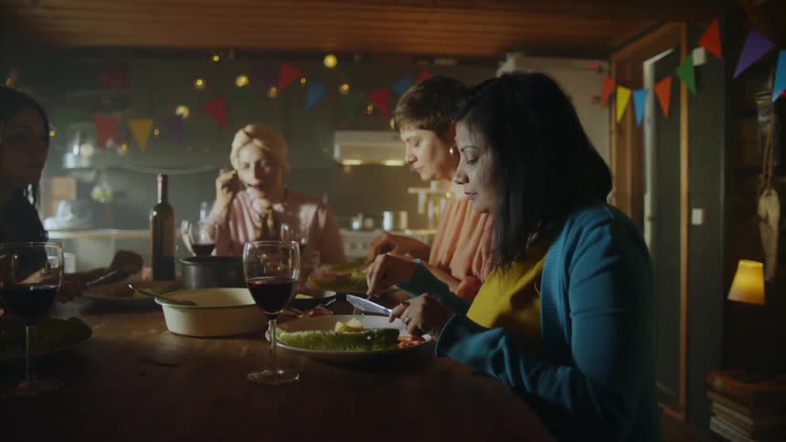 People sit around table eating