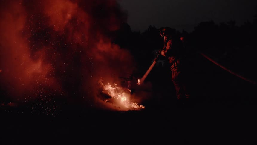 A firefighter attempts to extinguish a fire