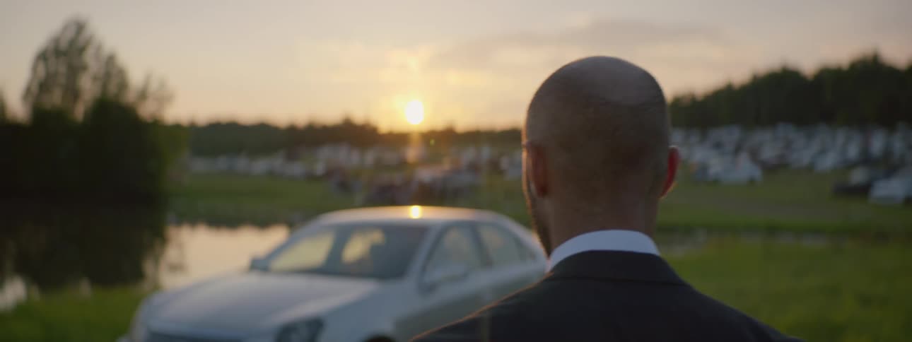 Suited Man Setting Car On Fire