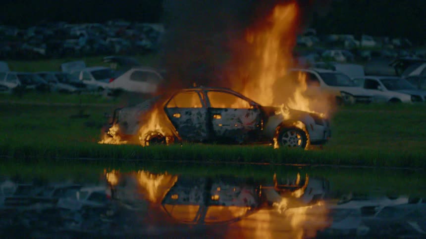 Firemen Extinguishing Burning Car