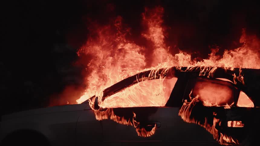 Firemen Extinguishing Burning Car