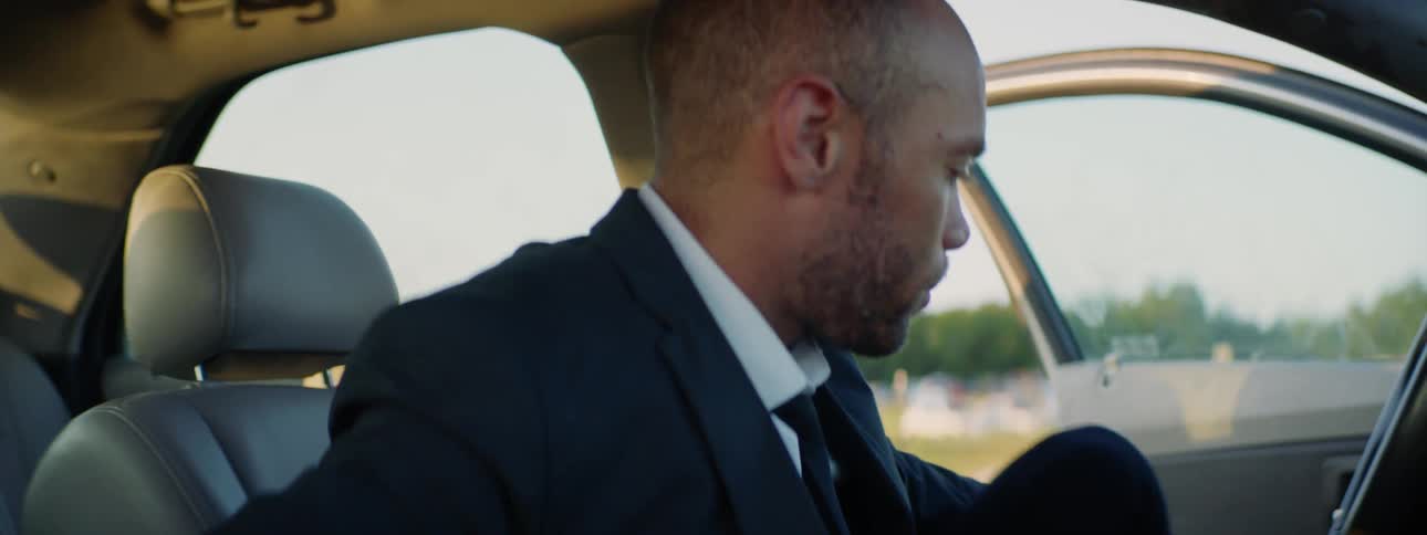 A man exits the driver seat of a car