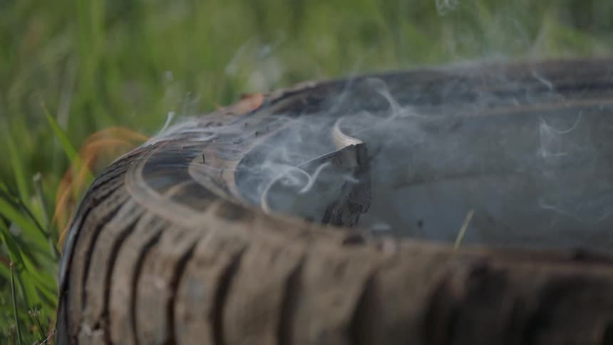 A tire burns in a fire