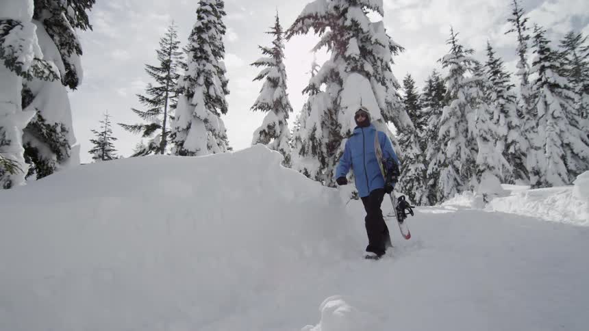 A man is walking down the snow