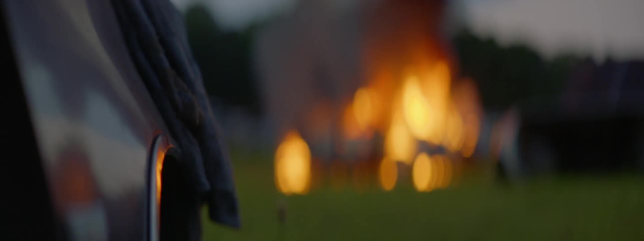 A fire is burning on the grass