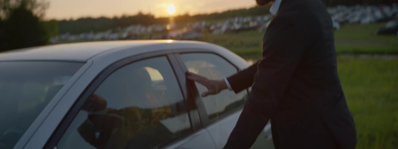 Suited Man Setting Car On Fire