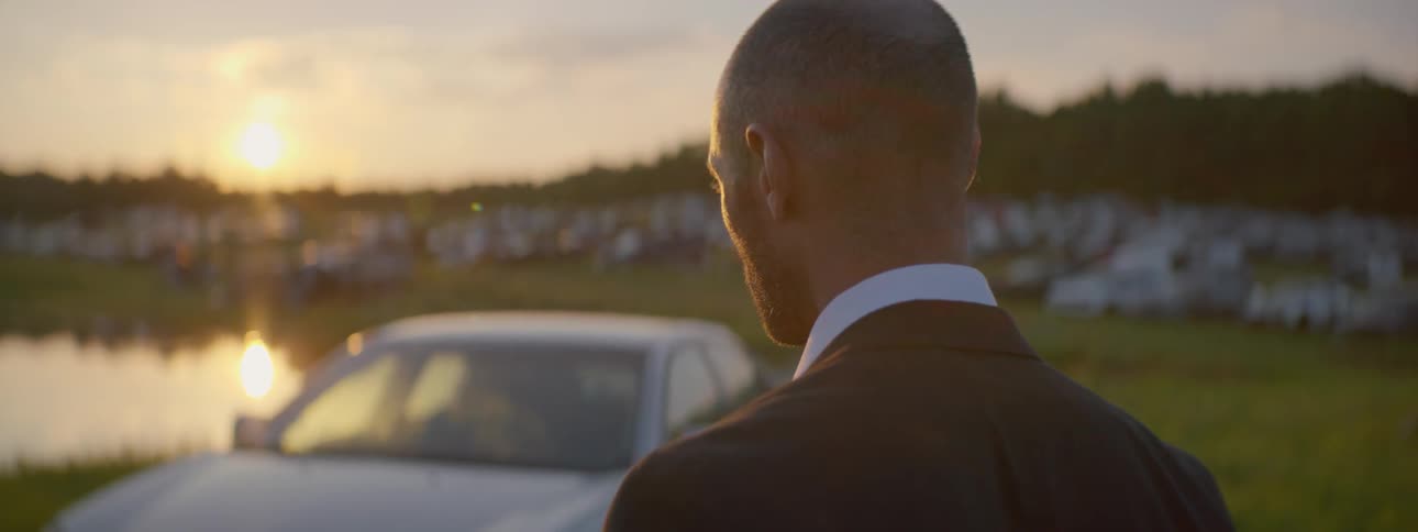 Suited Man Setting Car On Fire