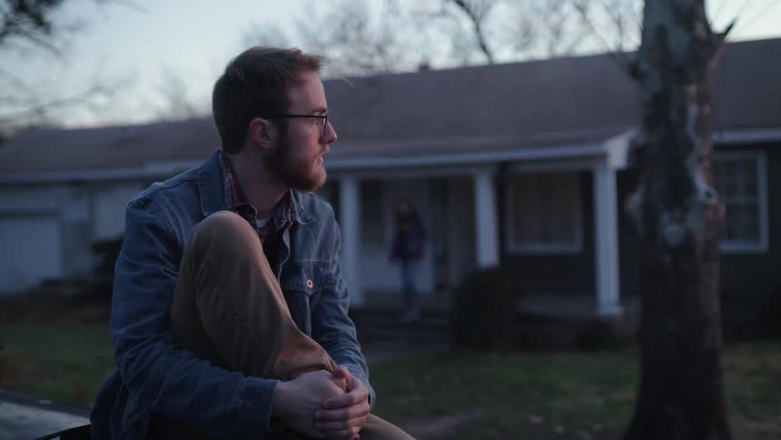 A man is outside sitting