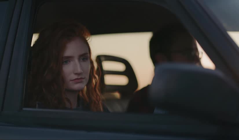 A man driving a car with a woman in the passenger's seat