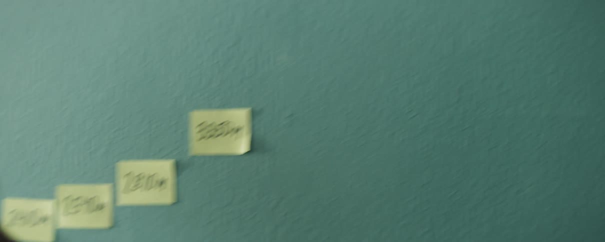 Multiple written messages on sticky notes placed on a wall
