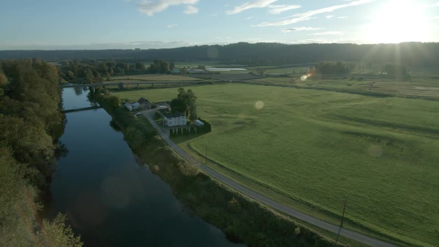 A stream weaves through farmlands