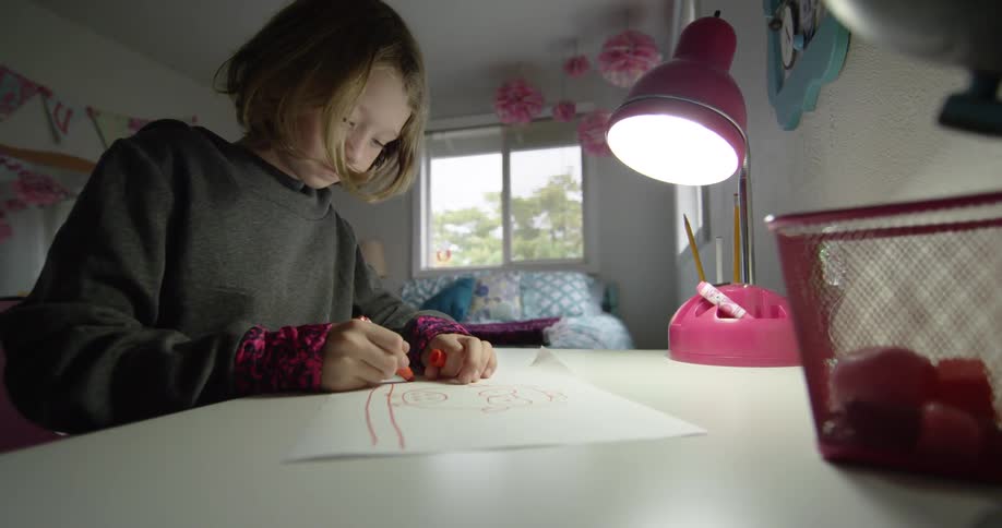 Girl Drawing At Desk