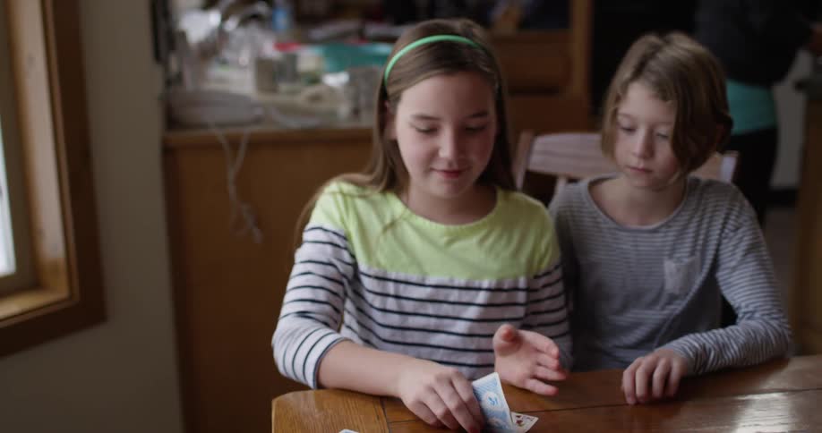 Children are playing cards