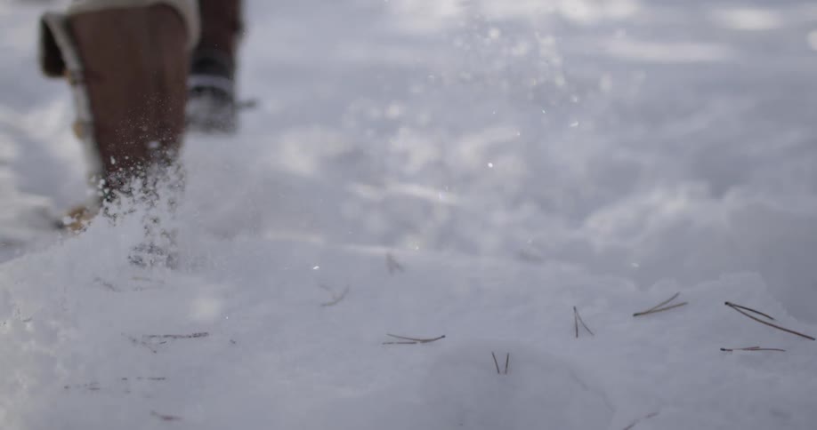 A woman walks through the snow