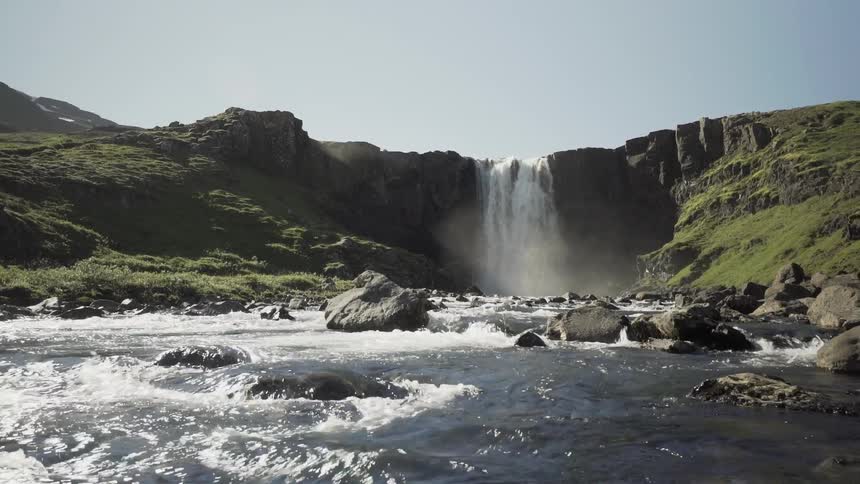 A waterfall in the background as the river flows