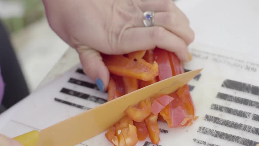 A person is cutting peppers