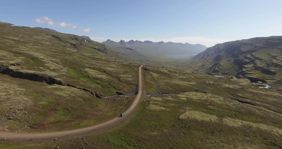 A car is driving down the mountain