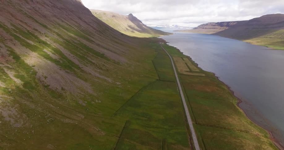 A road running alongside a mountain lake