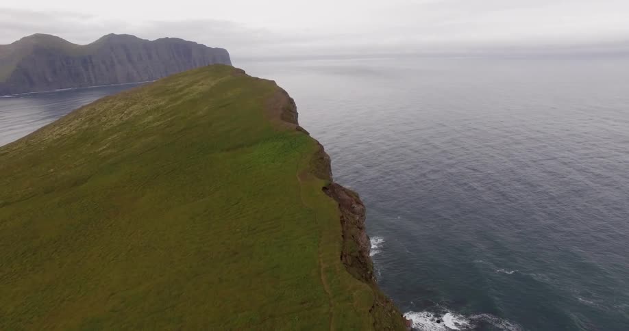 A cliff is shown alongside the ocean