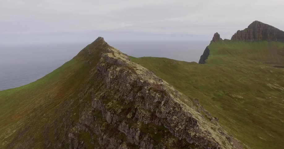 A tall mountain peak overlooking the ocean