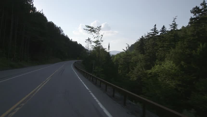 A car is driving down the road