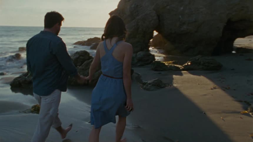 People walking down a beac