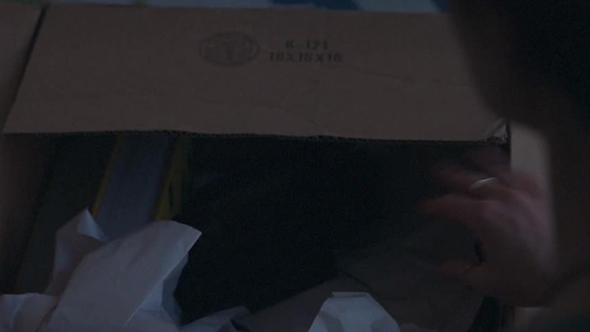 A person opening a box
