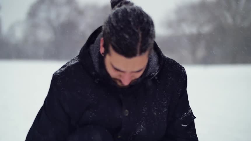 A man is standing in thesnow