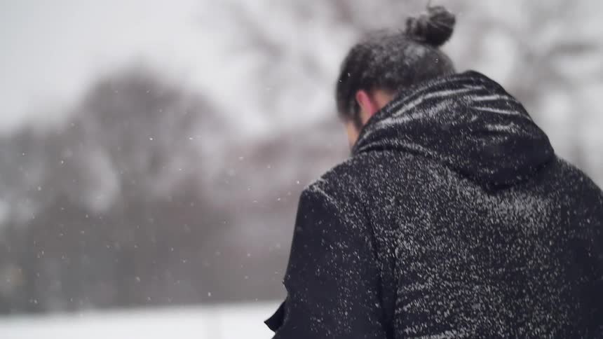 A man walks in a snowstorm
