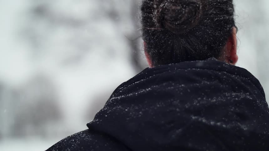 A man is walking in the snow
