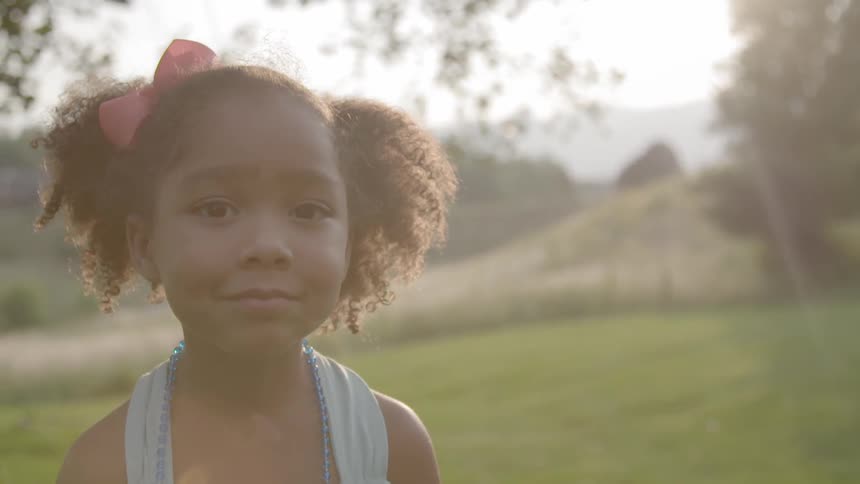 Child is standing in a field