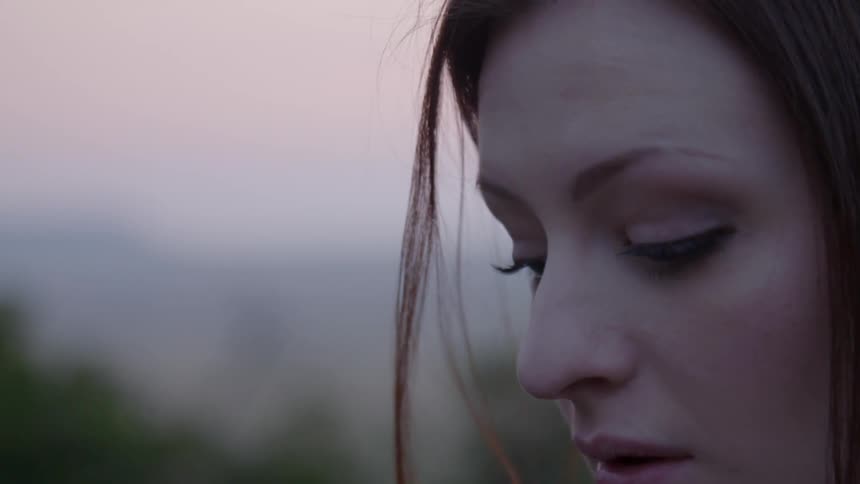 A woman standing outside at sunset