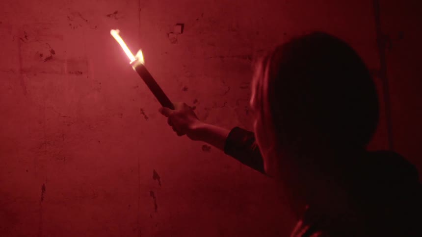 A person holding a flare