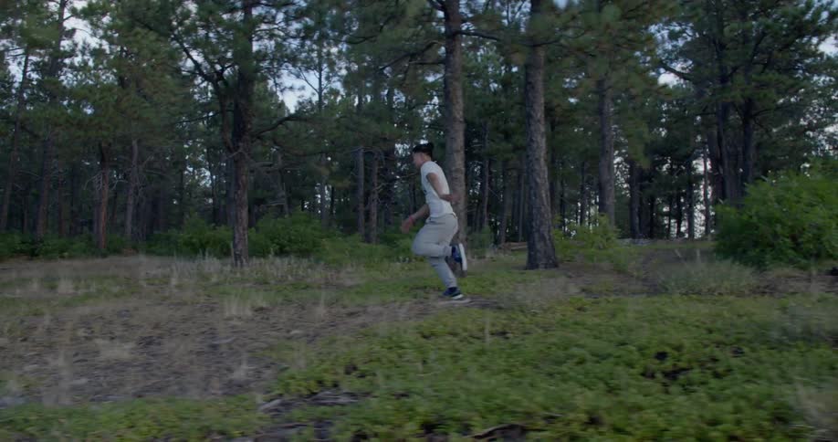 A man running through a wooded area
