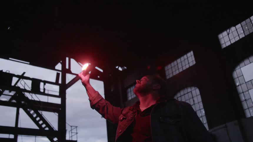 A man is holding a flare