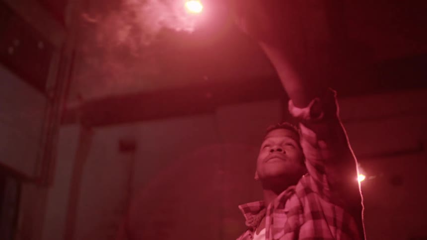A man is holding a flare