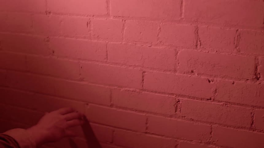 A person touching a wall
