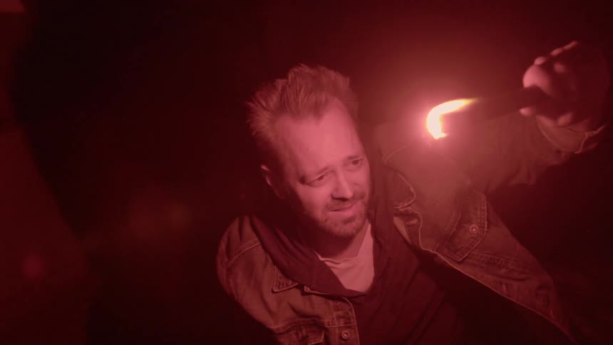 A man is holding a flare