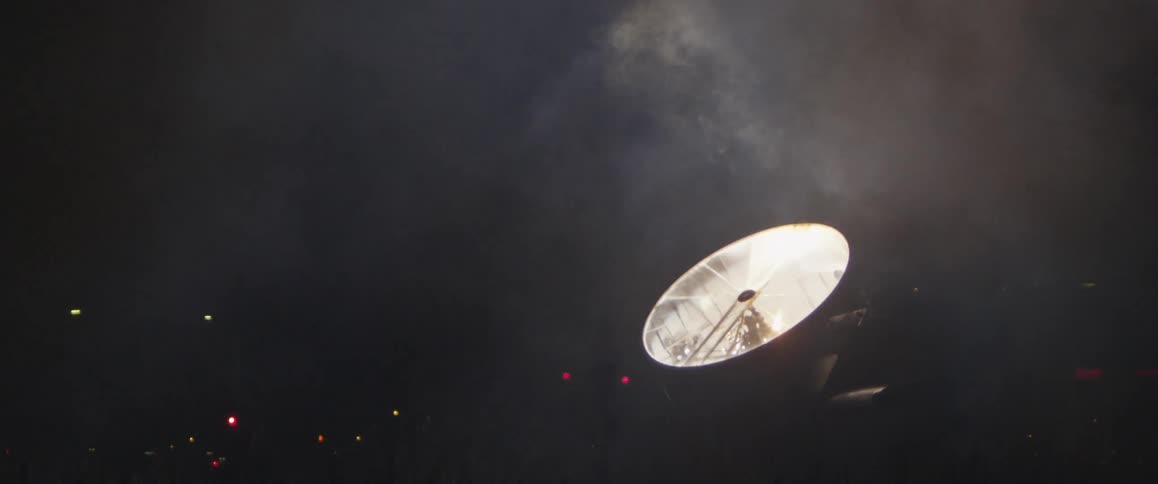 Fog floating over a spotlight at night