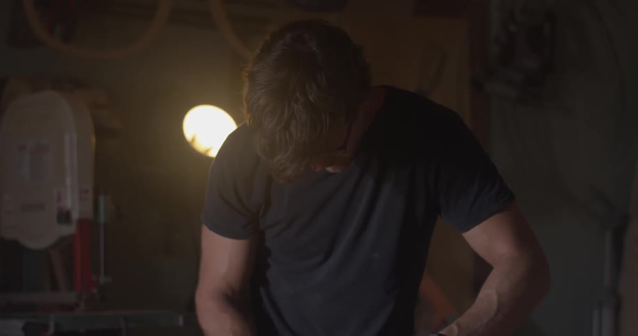 Man fixing or building an item in a wood shop