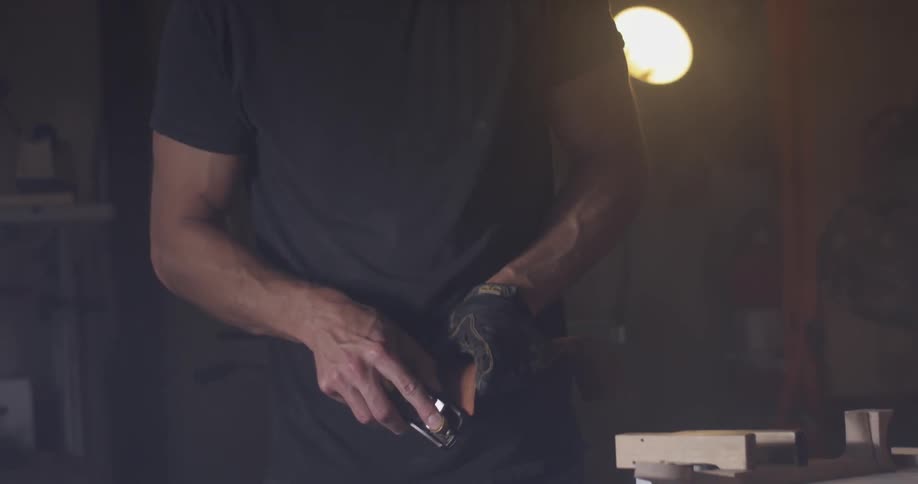 Carpenter Making Guitar In Workshop