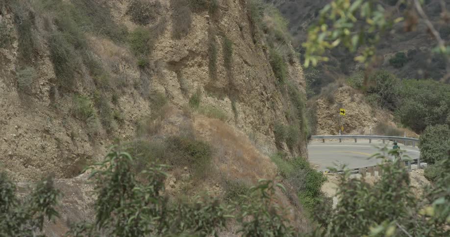 A man riding a bicycle up a mountain road
