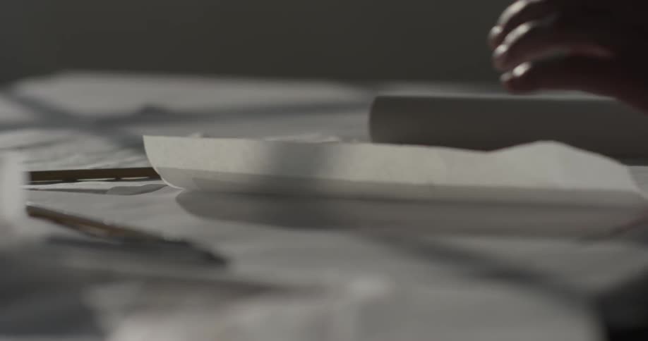 A person paging through pieces of paper